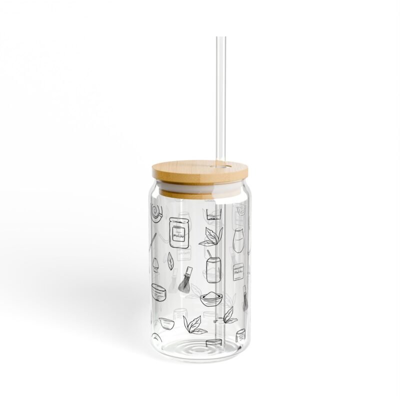 Clear glass tumbler with bamboo lid and straw, decorated with matcha-themed illustrations including matcha drinks, spoon, whisks, mug, and matcha leaves.