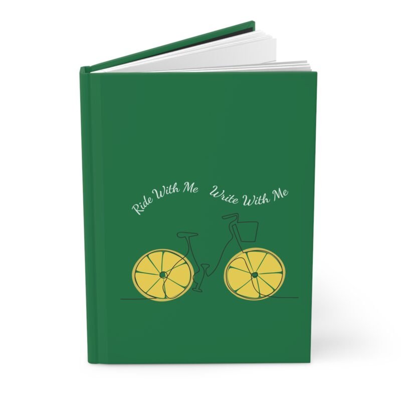 Green hardcover journal with a minimalist bicycle illustration featuring lemon slice wheels and the phrase ‘Ride With Me Write With Me’ above it.