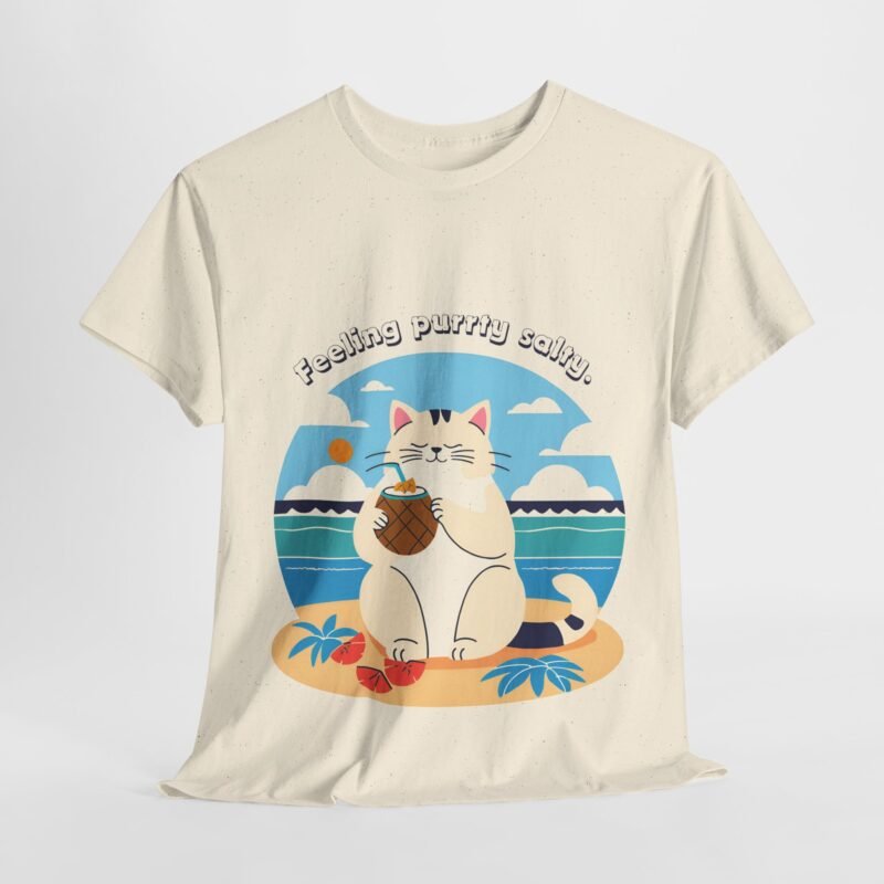 Natural beige color T-shirt with the phrase ‘Feeling purrty salty’ printed above a cat drinking pina-colada on the beach relaxing illustration