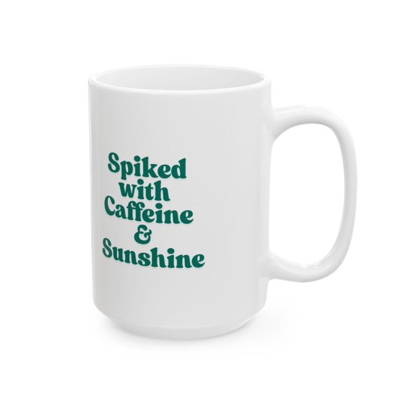 A ceramic mug features a sunny bright festive cactus illustration and writing of spiked with caffeine and sunshine