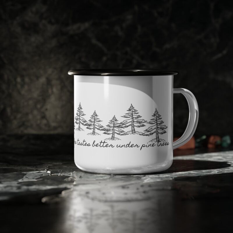 Vintage style black and white enamel mug with mountain , pine tree illustration , also phrase of coffee tastes better under pine tree design