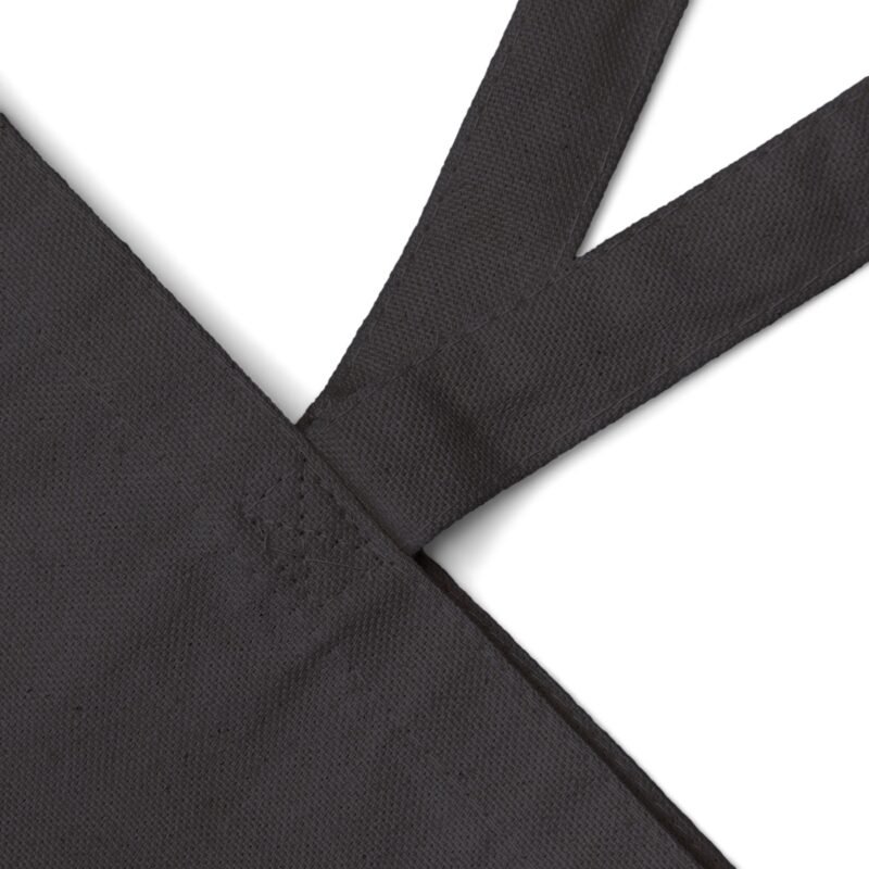 detail photo of a black cotton canvas tote bag on the strap