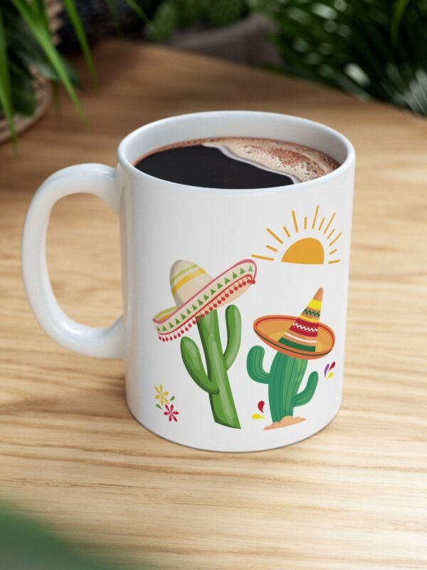 A ceramic mug features a sunny bright festive cactus illustration and writing of spiked with caffeine and sunshine