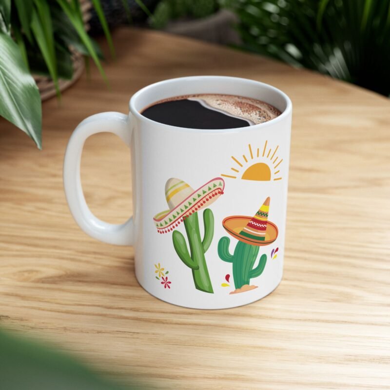 A ceramic mug features a sunny bright festive cactus illustration and writing of spiked with caffeine and sunshine