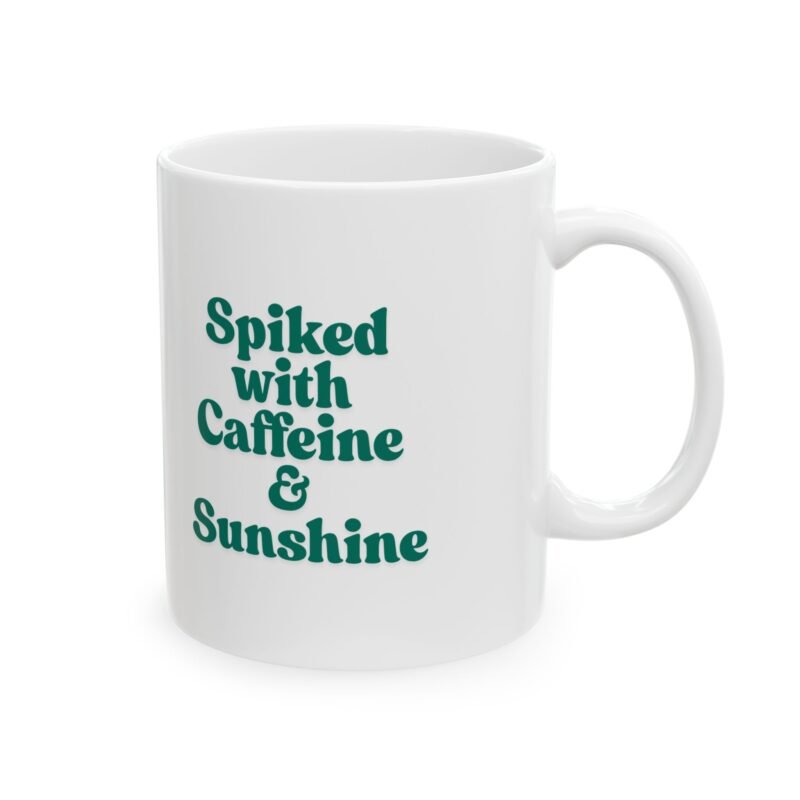 A ceramic mug features a sunny bright festive cactus illustration and writing of spiked with caffeine and sunshine