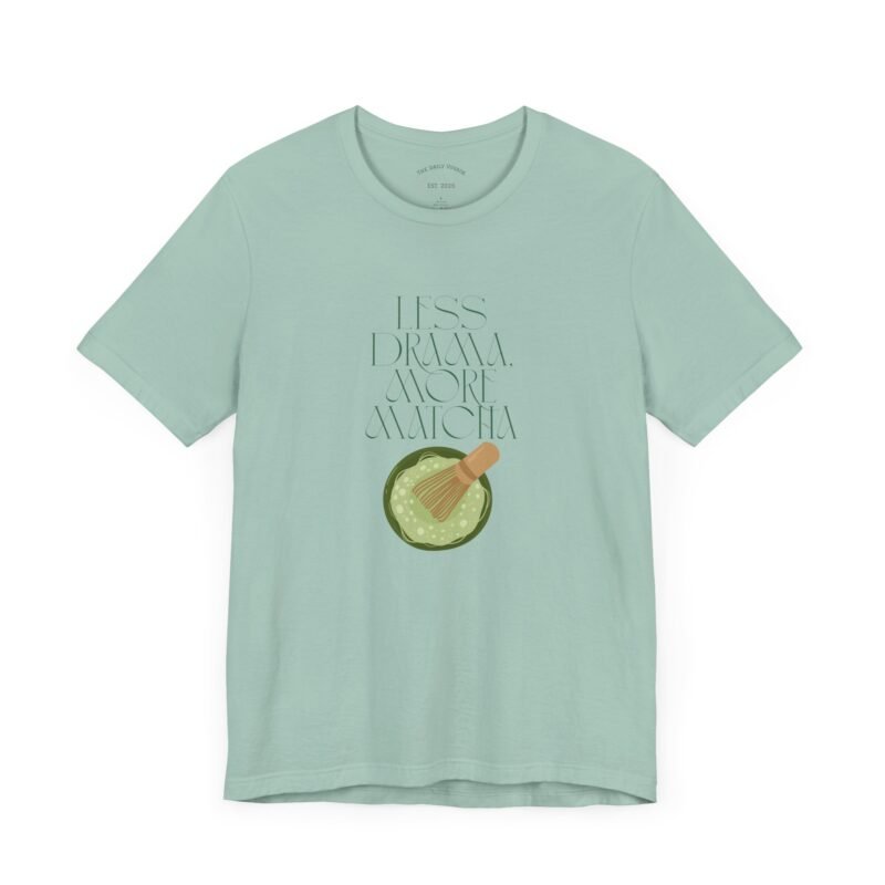 Dusty Blue T-shirt with the phrase ‘Less drama more matcha!!’ printed above a bowl of matcha green tea and tea whisker illustrations, unisex cotton t shirt