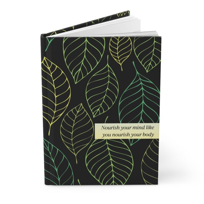 Black hardcover notebook with green and yellow leaf pattern and quote about nourishing the mind and body