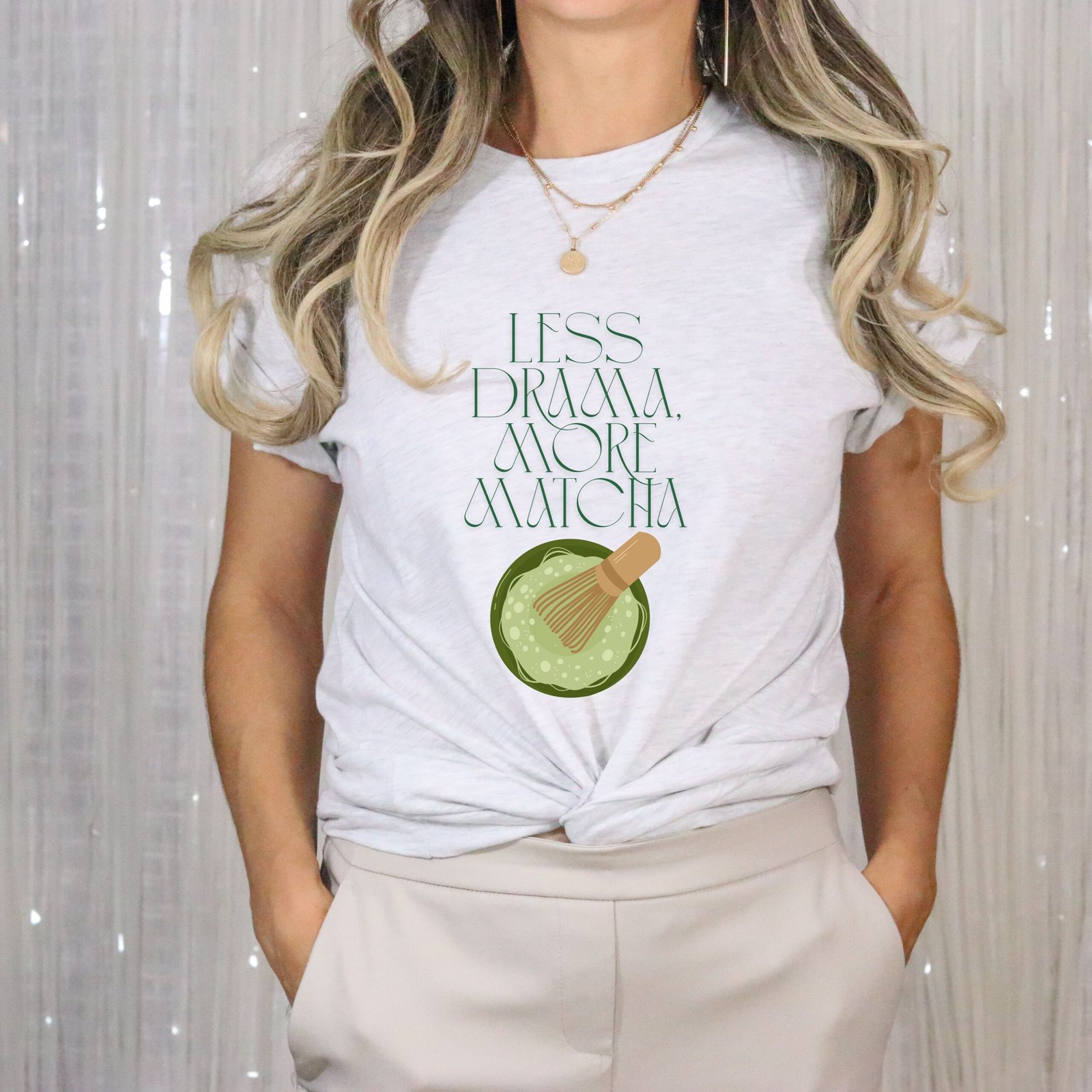 Ash white T-shirt with the phrase ‘Less drama more matcha!!’ printed above a bowl of matcha green tea and tea whisker illustrations, unisex cotton t shirt
