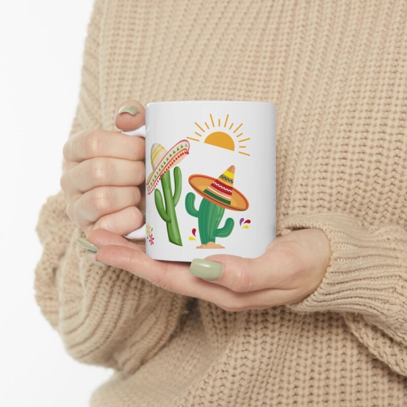A ceramic mug features a sunny bright festive cactus illustration and writing of spiked with caffeine and sunshine