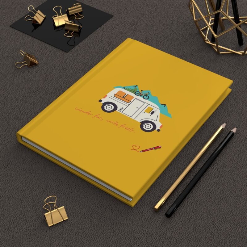 Yellow adventure journal with camper van, mountains, and "Wander far, write freely" quote on cover.