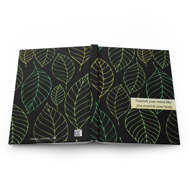Black hardcover notebook with green and yellow leaf pattern and quote about nourishing the mind and body