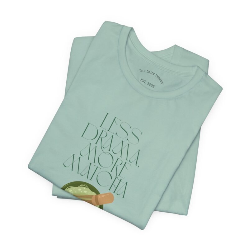 Dusty Blue T-shirt with the phrase ‘Less drama more matcha!!’ printed above a bowl of matcha green tea and tea whisker illustrations, unisex cotton t shirt